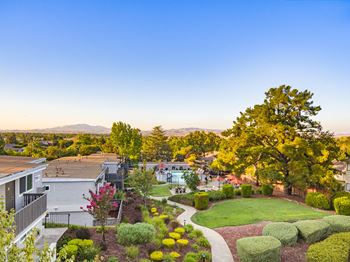 An aerial view of a neighborhood with houses and trees and a lawn